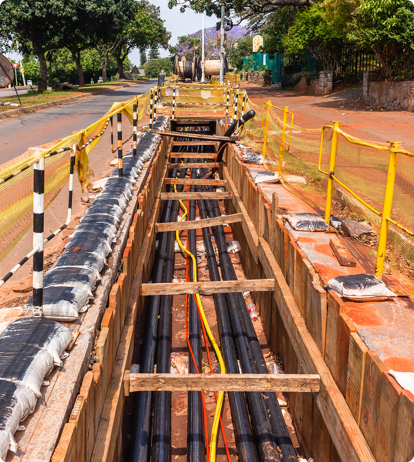 Trench with underground cables and barriers.